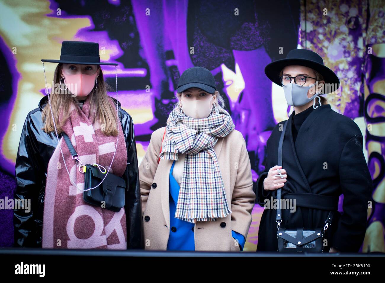 Moscow, Russia - 20 March, 2020 , fashionably dressed girls in wide-brimmed hats and caps, long woolen coats and raincoats with scarves`s Burberry in Stock Photo